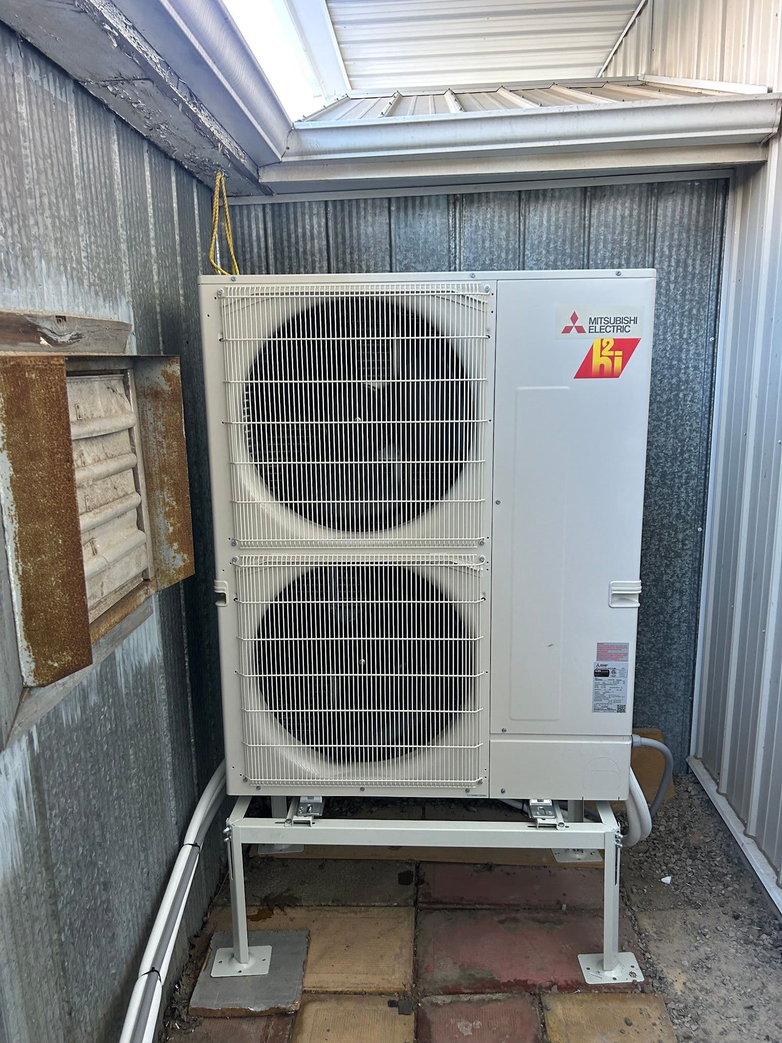 Two HVAC technicians in a service van reviewing customer feedback and job notes on a tablet after completing a furnace installation