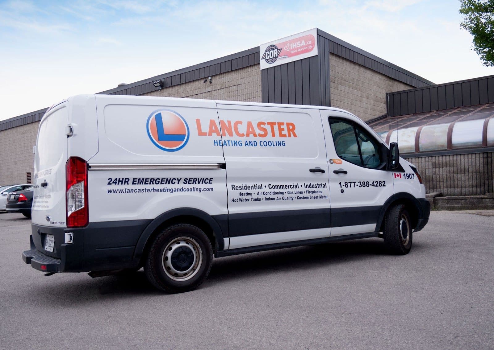 Two HVAC technicians in a work van reviewing customer feedback on a tablet after completing a furnace installation