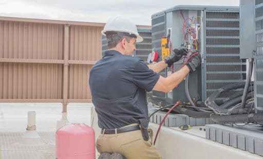 Two HVAC technicians in a work van reviewing customer feedback and recent Google reviews on a tablet after completing a furnace installation