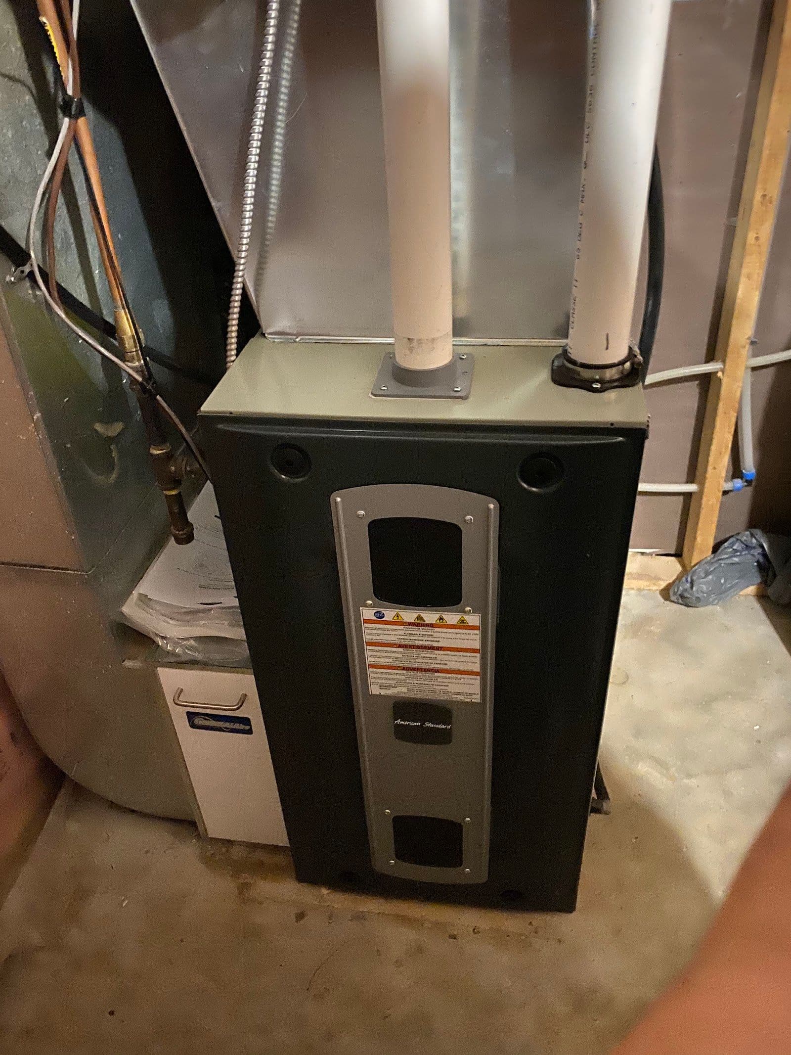 Two home comfort technicians in a work van reviewing customer feedback and recent Google reviews on a tablet after completing an HVAC installation