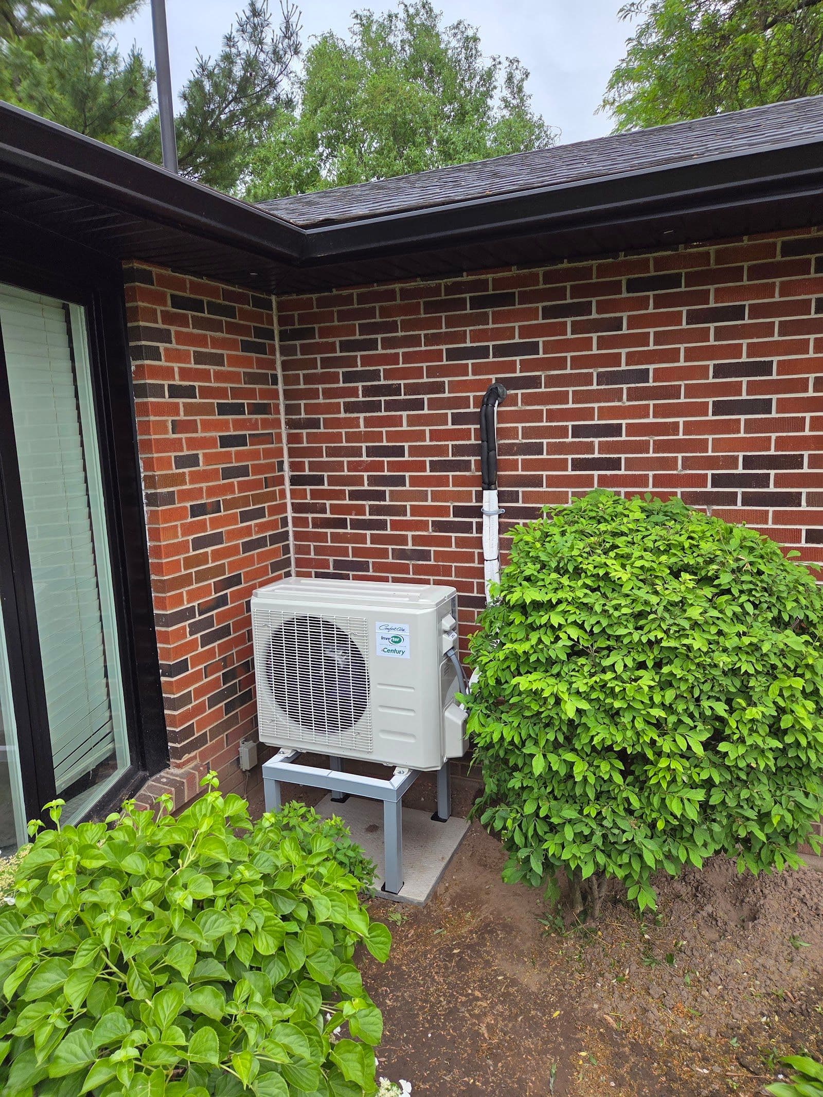 Two HVAC technicians in a work van reviewing customer feedback and Google reviews on a tablet after completing a furnace installation job